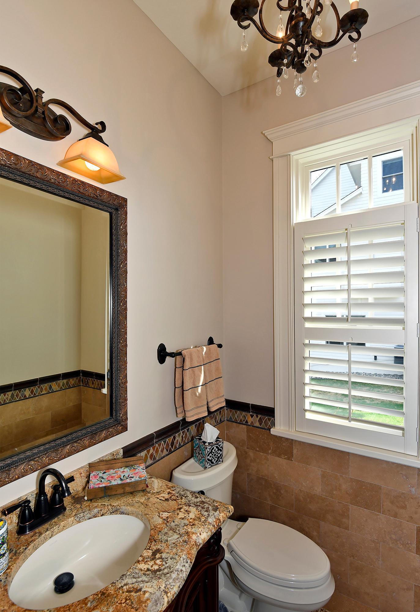 Main Floor Powder Room with Travertine Wainscoting & Mosaic Stone Floor