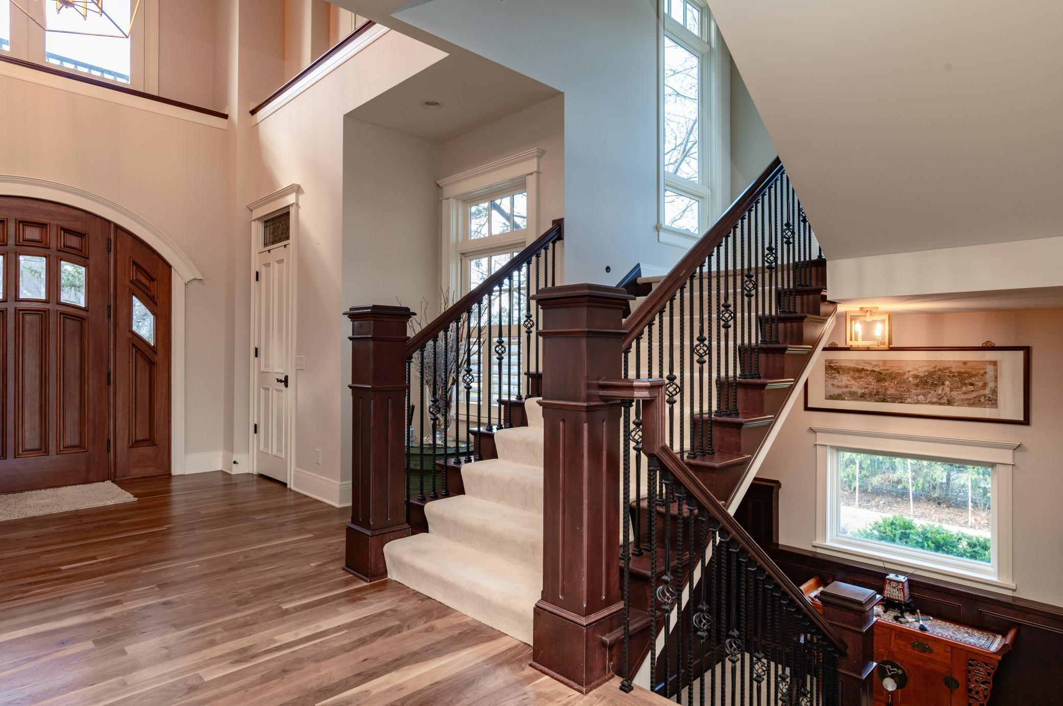Foyer and Open Staircase Bathed in Natural Light