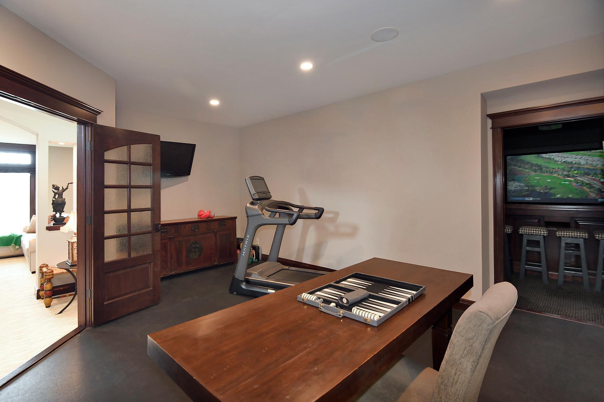 Seeded Glass French Doors Open to Flex Room with Access to Home Theater