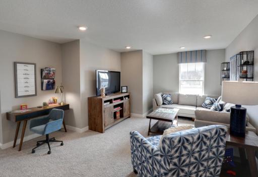 The home's upper level is equally impressive, as it features four bedrooms, two baths, laundry and this game room or loft area, which is sure to be a favorite hangout spot for the entire family! *photo of model with same floor plan.