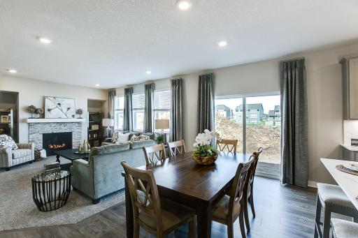 Seamlessly connected to the kitchen, the home's main level family room features a natural gas fireplace. Imagine watching a movie, relaxing after a day of work or entertaining neighbors in this space. *Photo of previous model.