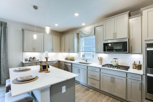 An open-concept floor plan throughout, the theory is epitomized along the backside of the home, which seamlessly connects the kitchen, dinette and family room. *Photo of previous model. Selections & colors may vary, please see agent for details.