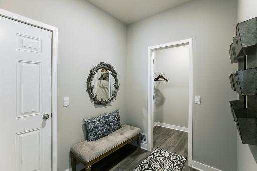 Mud room with loads of space and a generous walk-in closet. Model photo. Options and colors will vary.