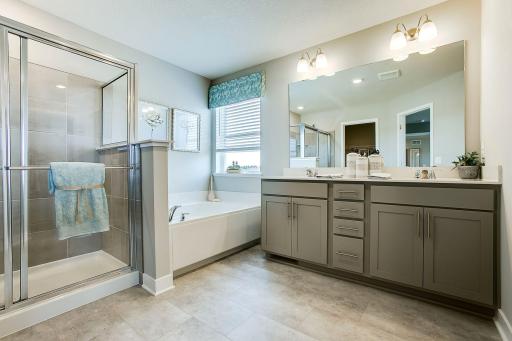 Primary Bath with double sinks, soaking tub and separate shower. *Photos of former model. Options and colors will vary.
