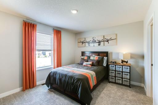 Each of the home's spacious secondary bedrooms feature well thought out window locations, plus each have their own walk-in closet. *Photo of previous model. Selections may vary, please see agent for details.