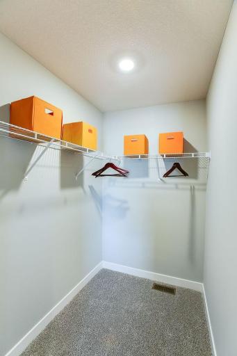 Each of the home's spacious secondary bedrooms feature well thought out window locations, plus each have their own walk-in closet. *Photo of previous model. Selections may vary, please see agent for details.