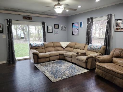 Spacious main level living area with large window and patio doors that lead to patio area.