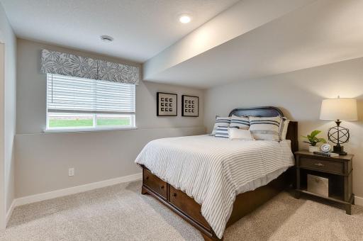 The 5th bedroom rests in the finished basement with large windows. Photo of Model Home. Options and colors may vary. Ask Sales Agent for details.