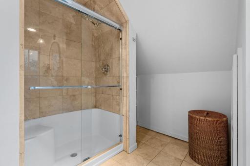 Glass Enclosed Tiled Shower in Owner's Suite