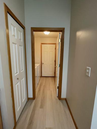 Hallway from garage enters into laundry area.
