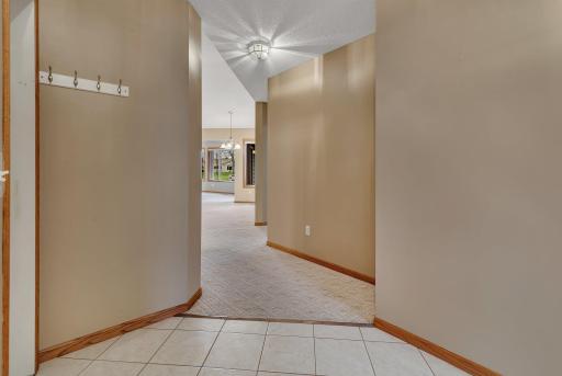 Tiled, wide entryway with access to garage