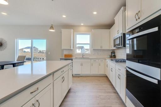 Signature kitchen with white cabinets. Stunning open layout. *PICTURES OF PREVIOUS MODEL HOME, SELECTIONS AND FINISHES TO VARY.