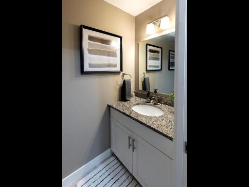 The perfect main floor powder bath complete with tile floors and natural stone countertops.