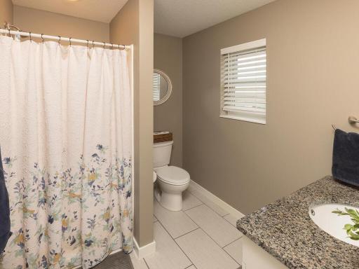 3/4 master bath; all bathrooms in this home have tile floors and natural stone countertops!