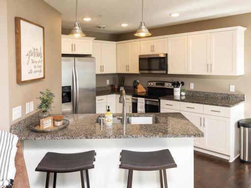 Natural stone countertops, stainless steel appliances, and plenty of storage and countertop space!