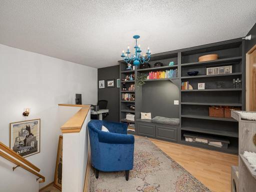 Upstairs, discover a versatile loft space perfect for a reading nook or home office, complete with custom storage options.