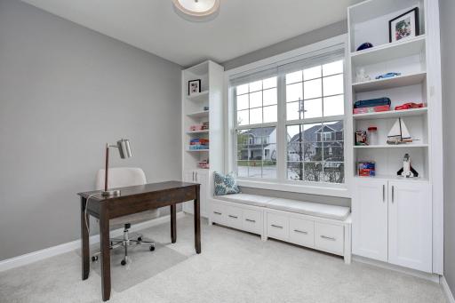 Main floor office with useful built-ins allows everything to have its place. Window overlooks the front yard and provides great natural light. Cuddle up with your favorite book on the bench.
