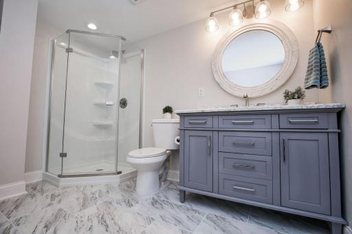 Recently finished lower level bathroom is beautiful and located near the fifth bedroom.