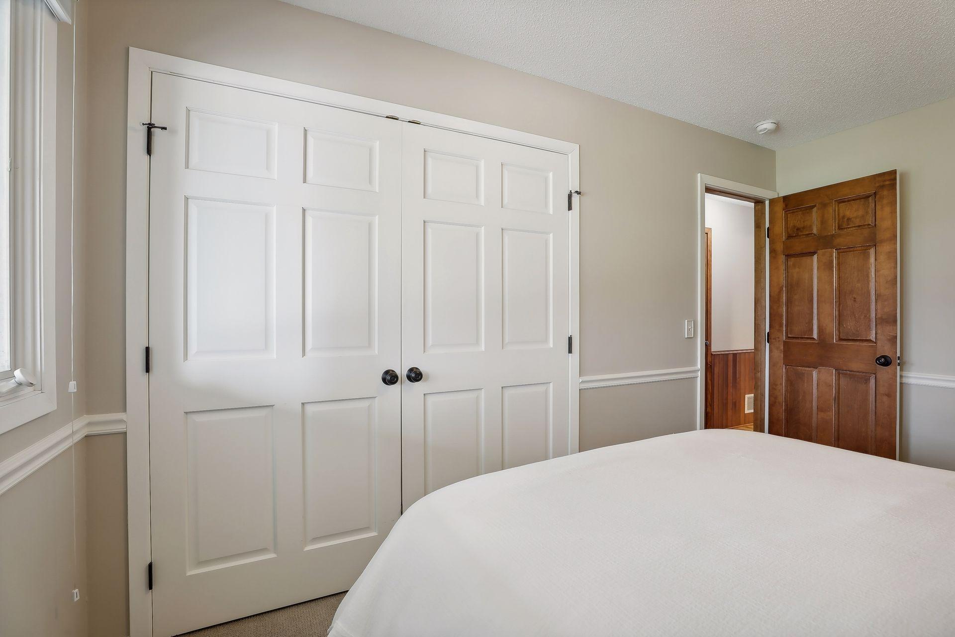 Spacious main level bedroom #2. Large closet and white, 6 panel doors.