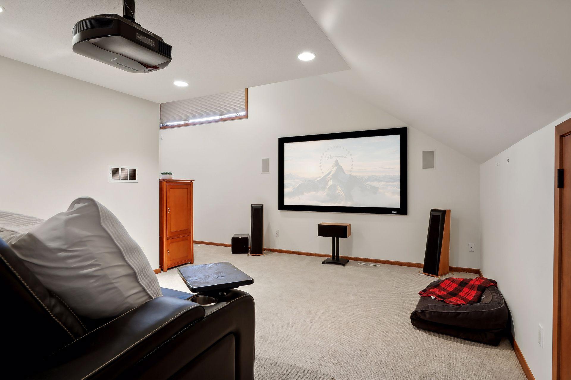 Get your popcorn for Friday night movie nights! This upper level space is currently setup as a theater but a fabulous space to create your own upper level space based on your personal needs.
