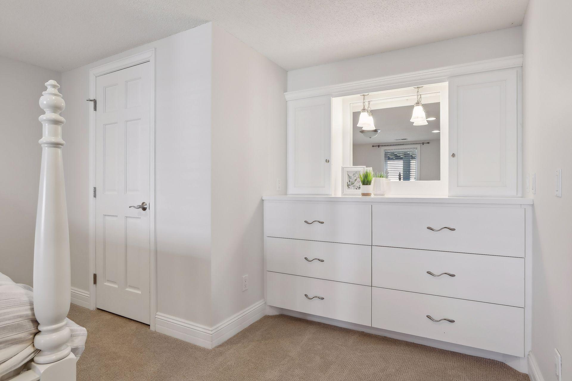 Spacious 4th bedroom in the LL offers a walk-in closet and fabulous built-in with mirror.