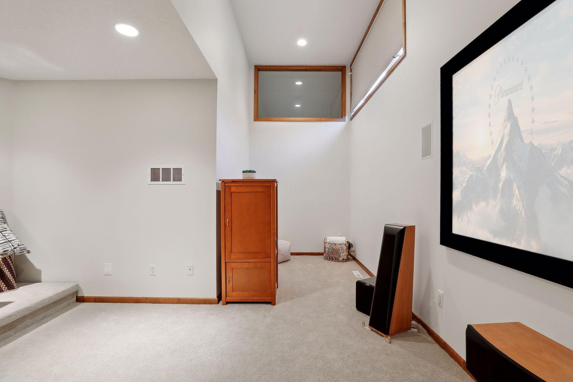 Cozy nook in the theater room offers high ceiling! Read a book, space for the pets, future closet...bring your imagine or enjoy the flexibility this extra space offers.