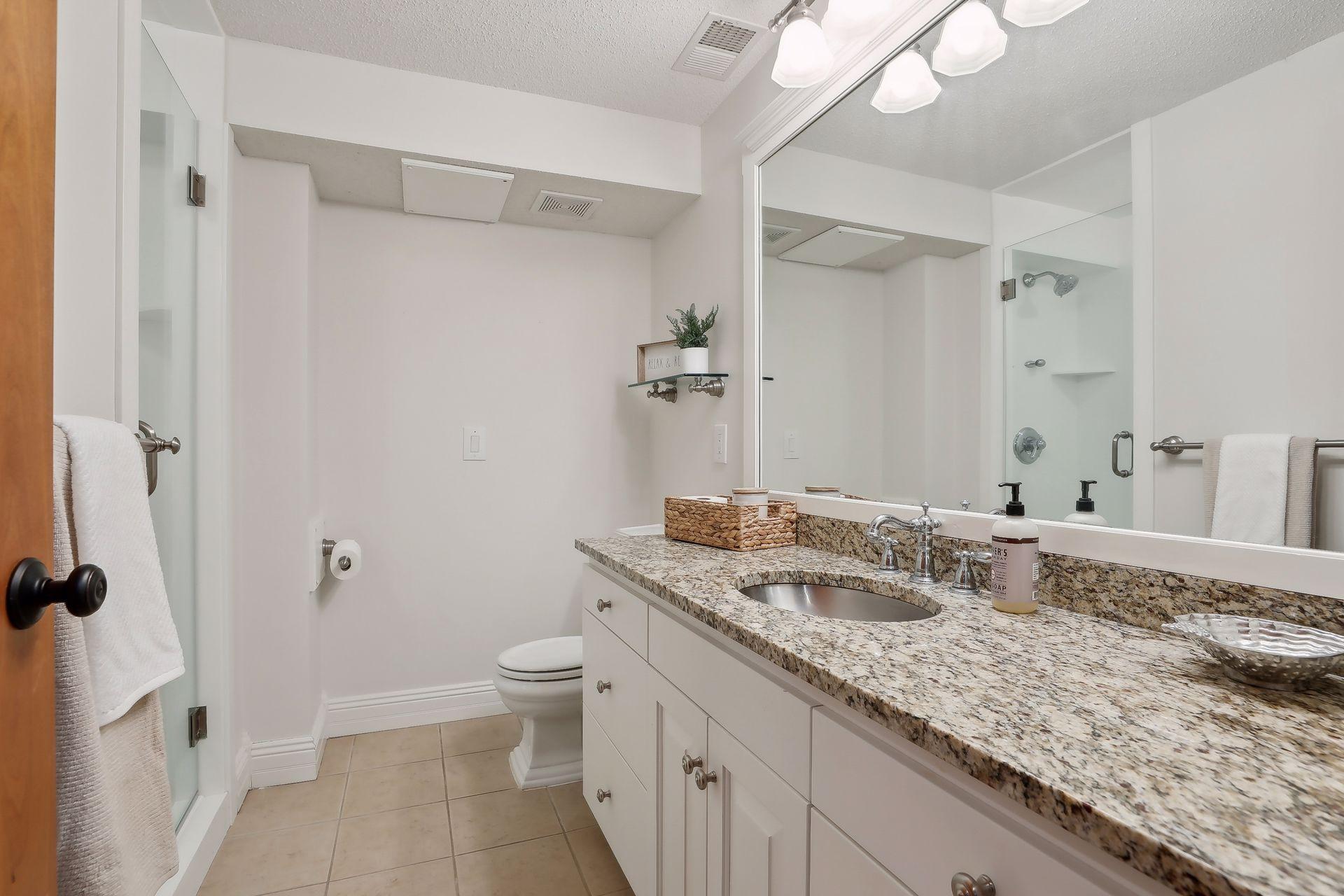 3/4 bathroom in the basement offers ceramic tiled floors, Granite countertops and walk-in shower!!