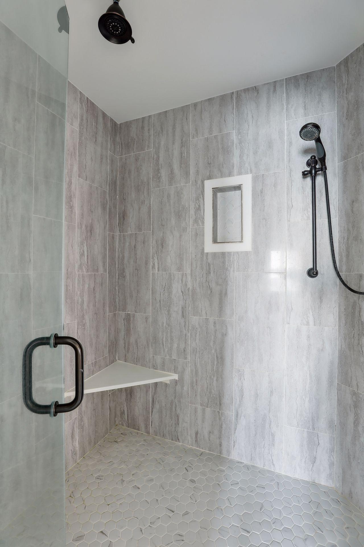 Modern walk-in shower with beautiful ceramic tiled designed.