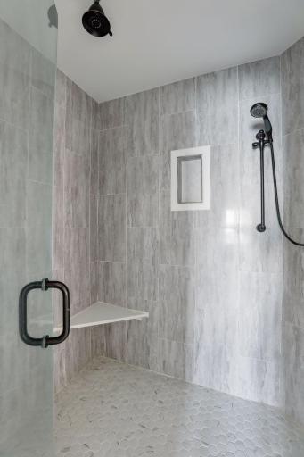 Modern walk-in shower with beautiful ceramic tiled designed.