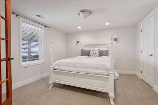Spacious 4th bedroom in the LL offers a walk-in closet and fabulous built-in with mirror.