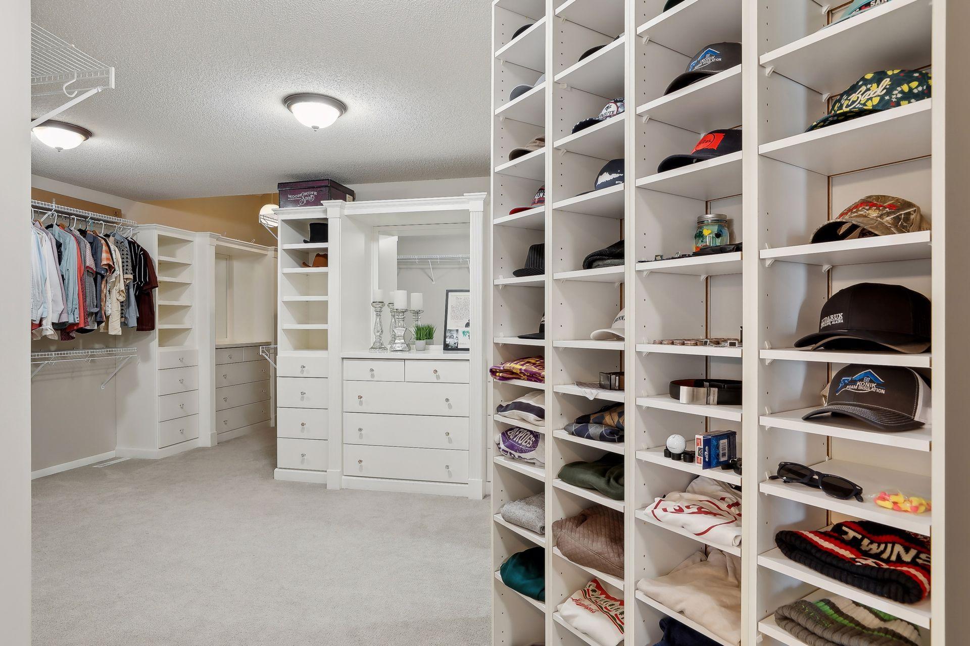 Dreamy primary closet with an abundance of built-ins, drawers, mirror and just about anything you'd imagine in the perfect closet space!!