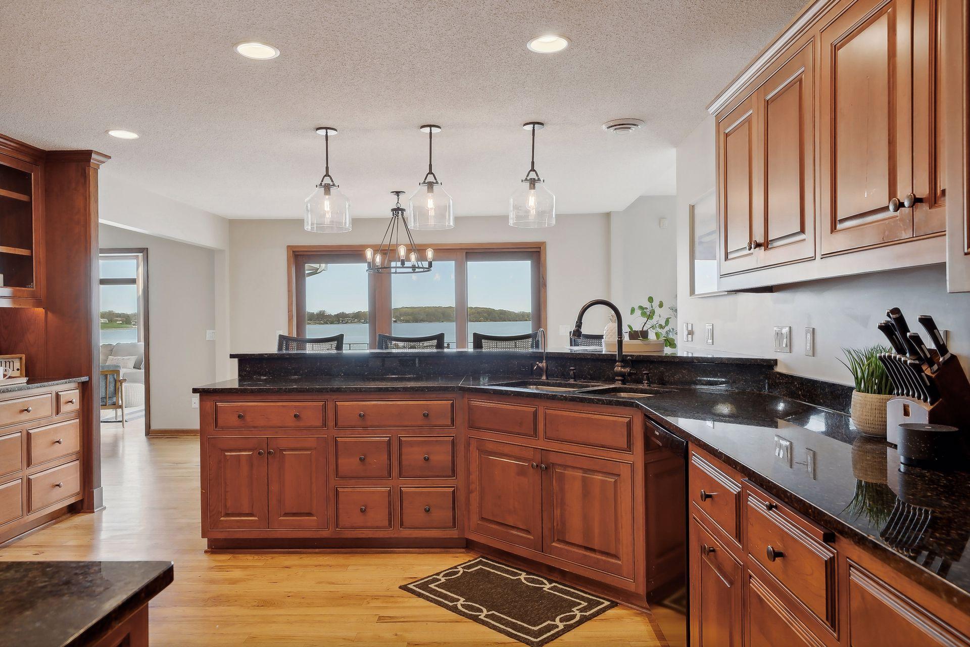 Preparing dinner...those lake views are almost everywhere! Oversized breakfast bar makes for easy dinner nights!