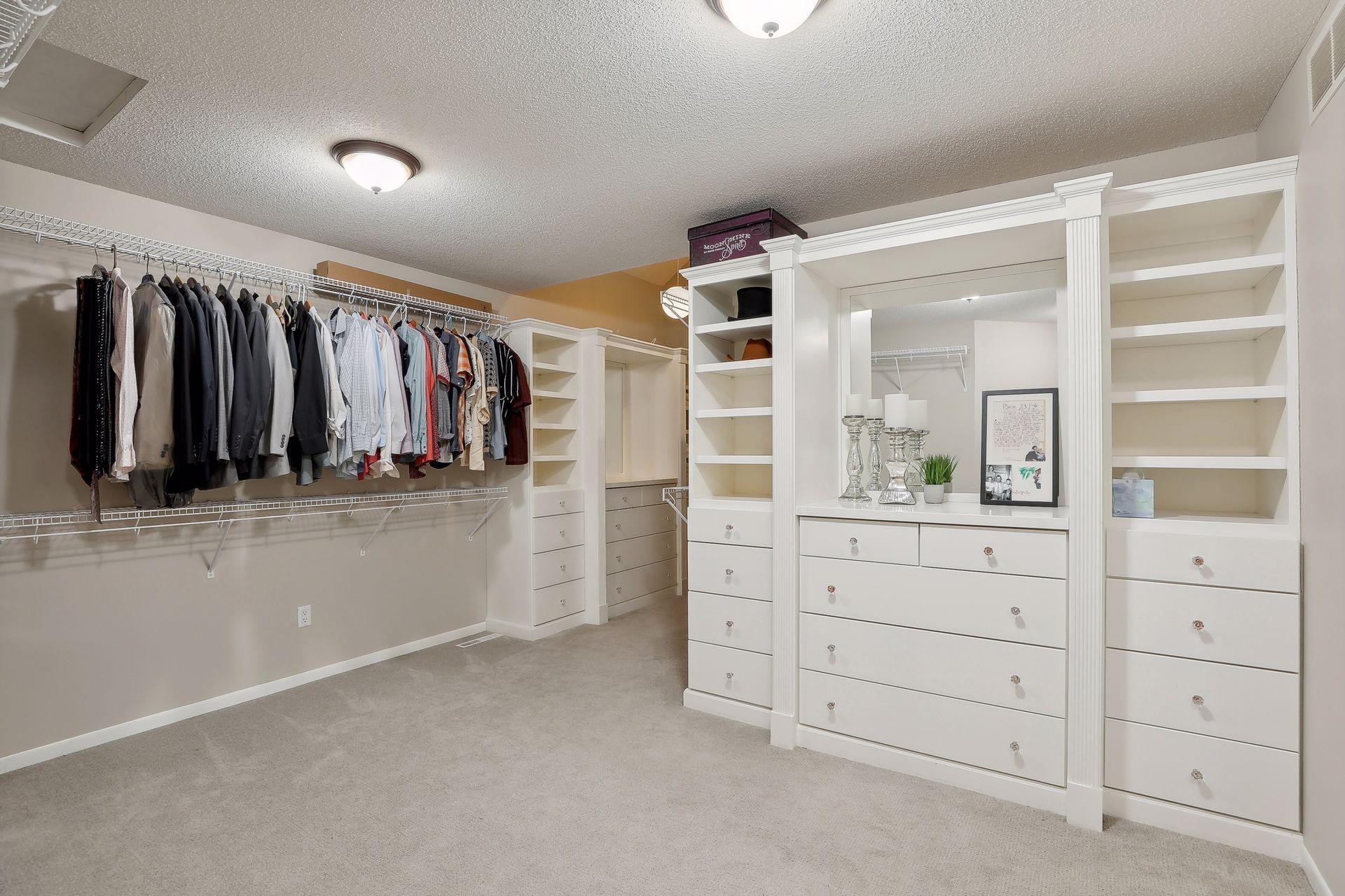 Dreamy primary closet with an abundance of built-ins, drawers, mirror and just about anything you'd imagine in the perfect closet space!!