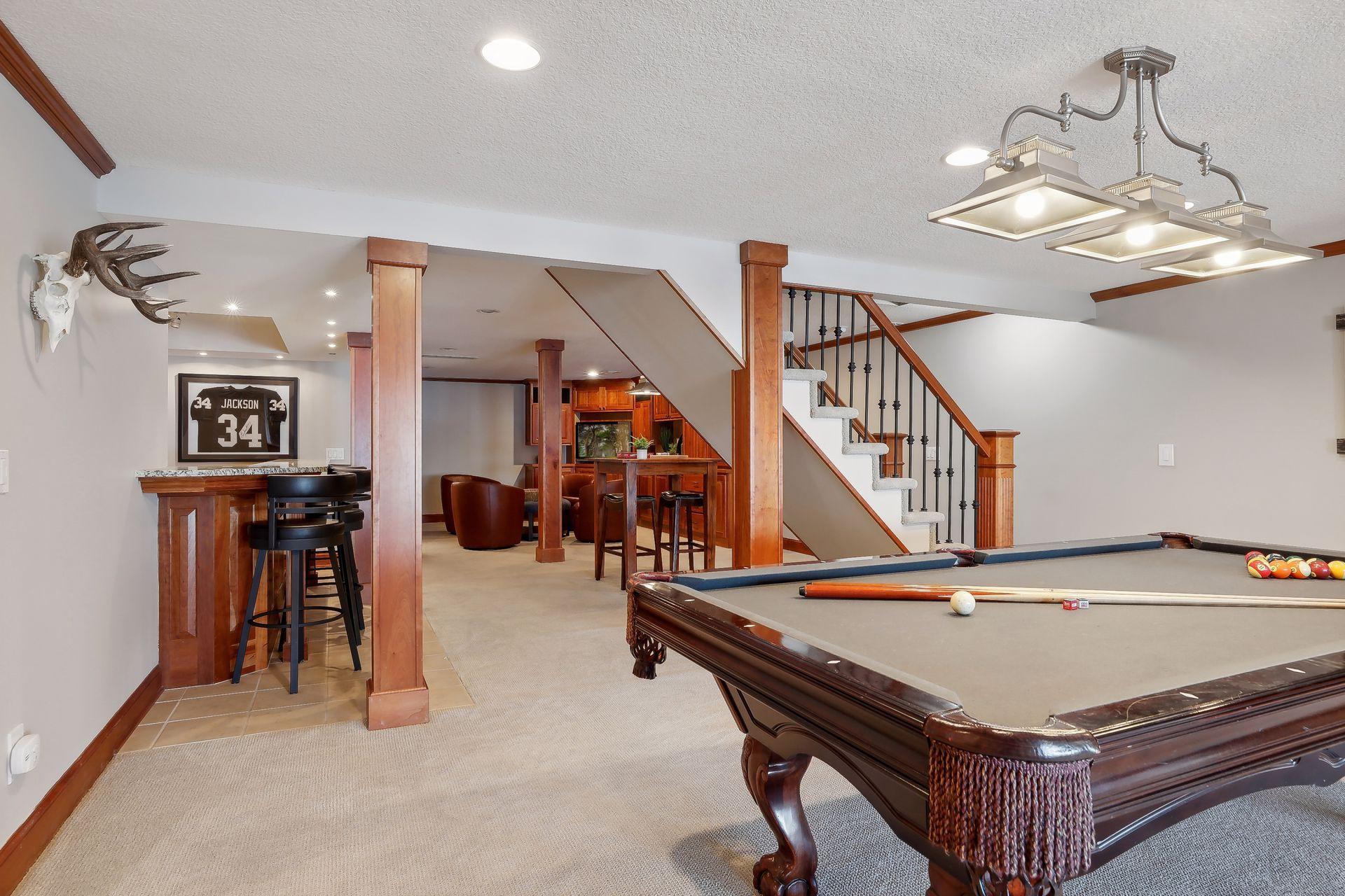 Amusement room is setup to entertain w/ it's billiards area and bar! You'll have so much fun entertaining your guests at the lake!