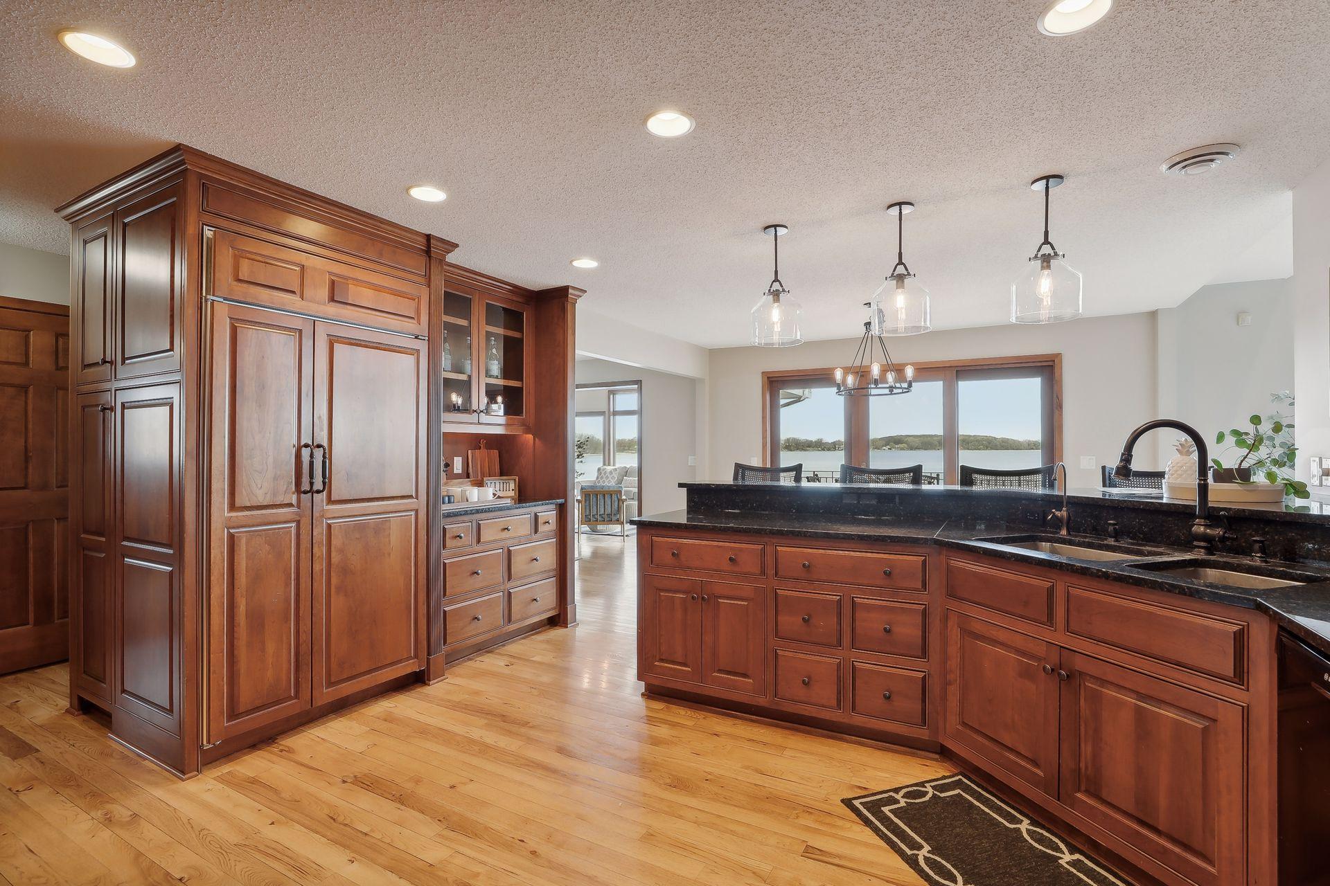 Elegant details, cherry paneled door refrigerator and an abundance of beautiful cabinetry.