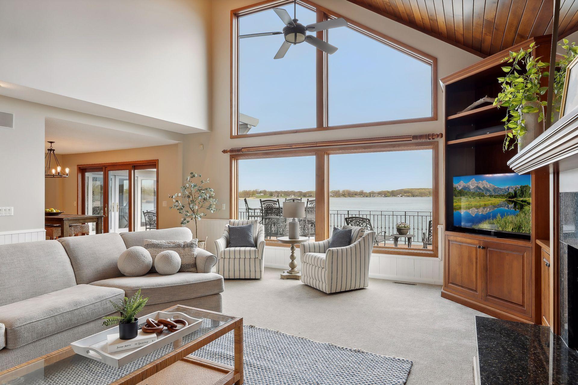 Neutral colors throughout. Towering living room ceilings. Floor to ceiling windows bring the sunshine and serene lake views inside. The views through those large windows will likely never disappoint!