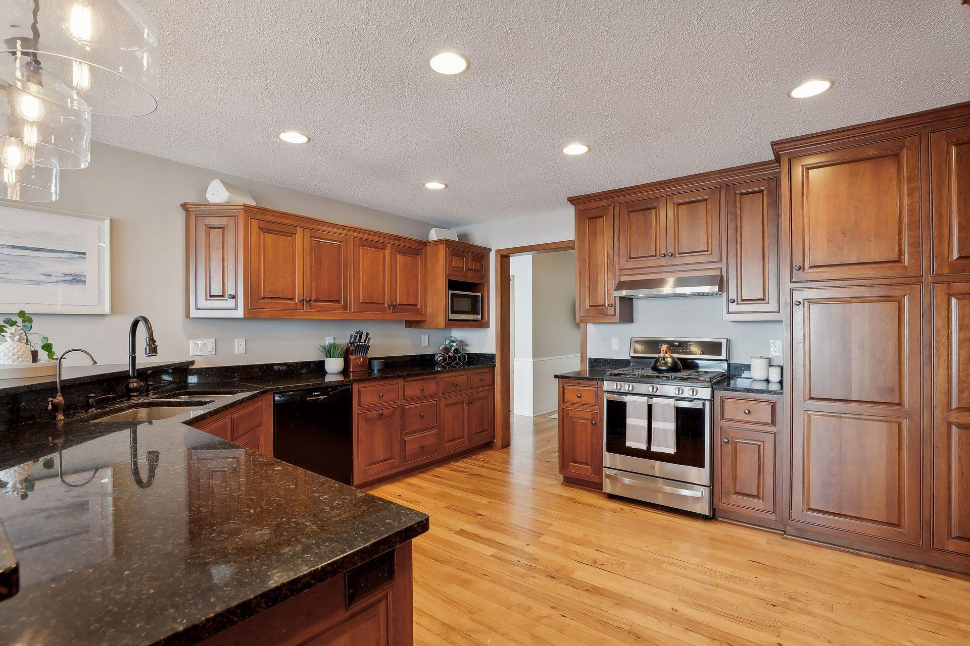 Gourmet kitchen w/ granite countertops, Stainless Steel Appliances, gorgeous Cherry, paneled cabinetry, pull out drawers and so much more!
