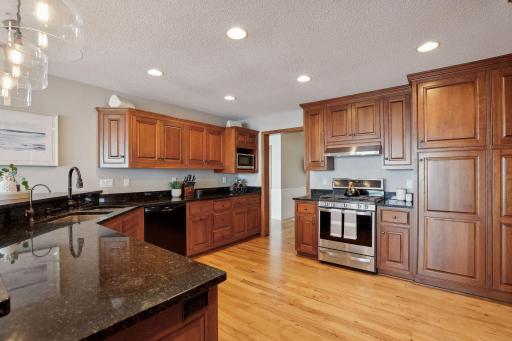 Gourmet kitchen w/ granite countertops, Stainless Steel Appliances, gorgeous Cherry, paneled cabinetry, pull out drawers and so much more!