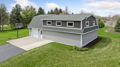 A building full of fun and extra, extra parking! 3 car garage stall and additional parking spaces for your lake guests. Many options for this great building. Lakeshore and this outbuilding, hard to find setup!!