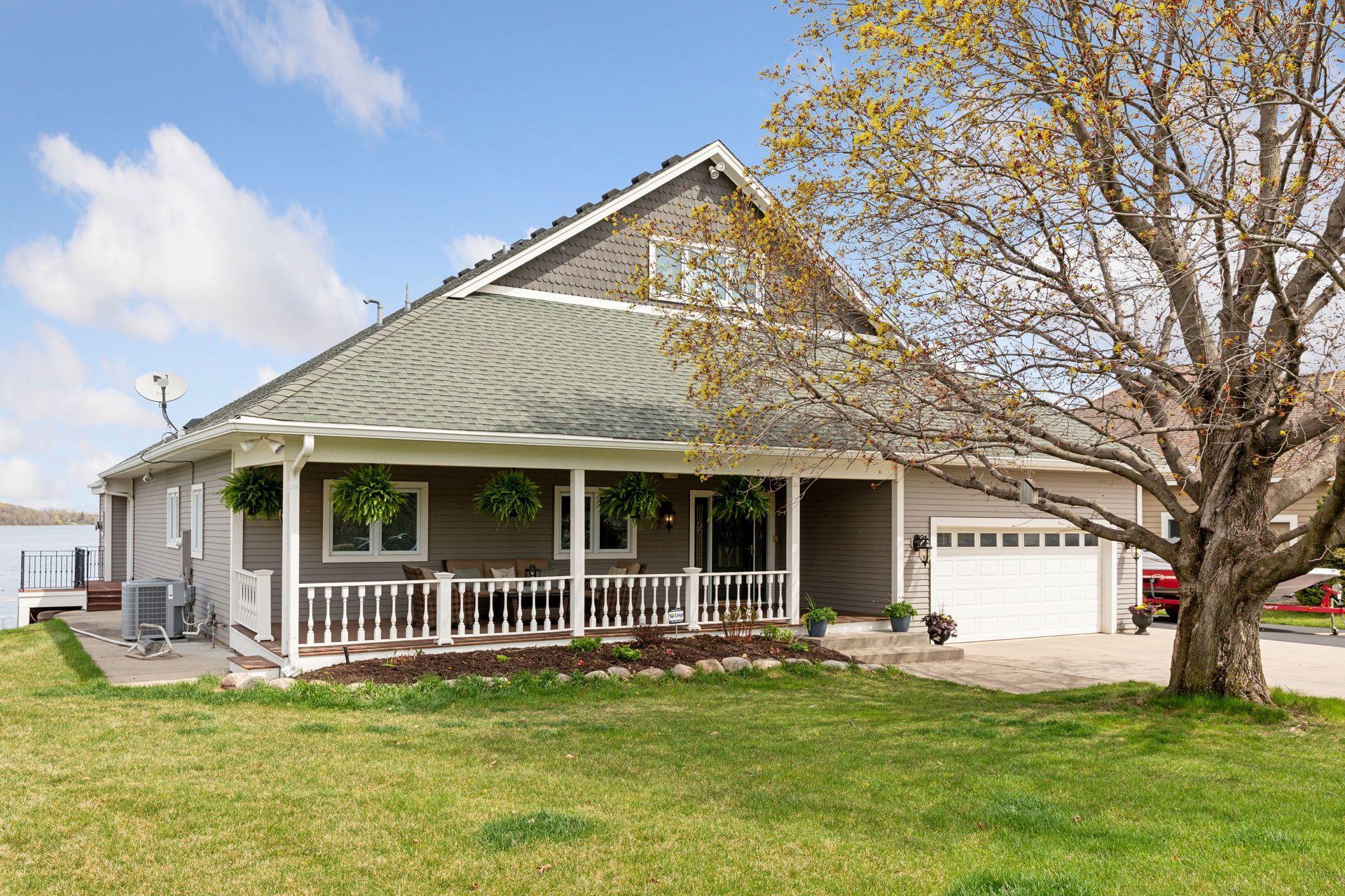 Standout curb appeal with this charming front porch and newer roof!