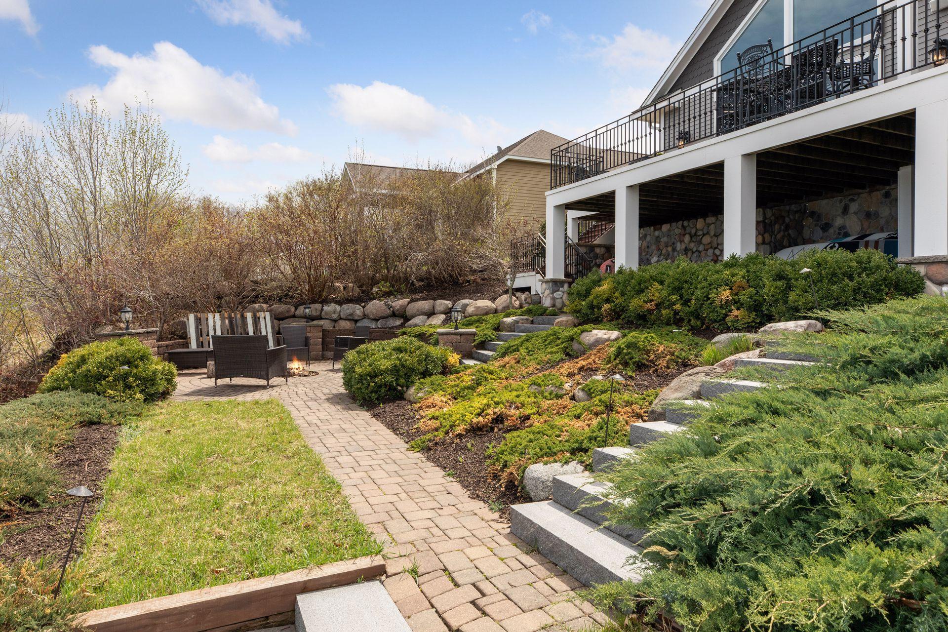 Beautifully landscaped yard with paver patios and walkways.