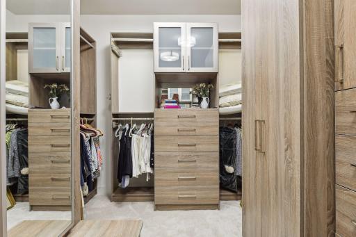 Impressive walk-in closet with an abundance of built-in organizational components