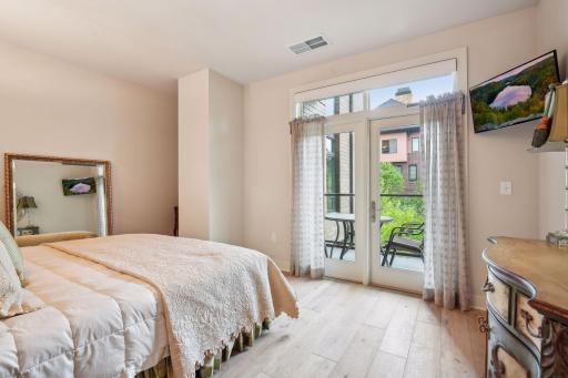 Second bedroom offers walk-in closet, balcony access and en-suite 3/4 bath