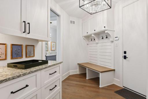 Sure to keep you organized, the Mud Room features a large walk-in closet, built-in boot bench with shiplap accents and a convenient drop station.