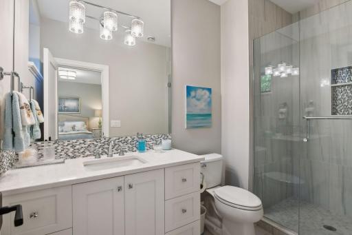 The private Â¾ en suite bathroom offers a comfort-height vanity and tiled shower.