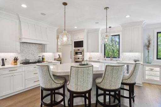 Equipped to please any chef, the Kitchen features comfort-height cabinetry with quartz countertops, soft-close drawers and doors, pull-out shelving, and custom utensil drawer and spice cabinet.