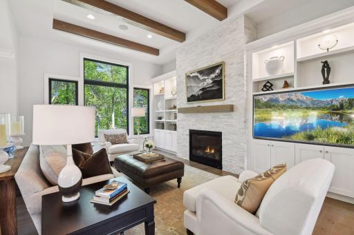 A true Great Room â this space features a 12-foot vaulted ceiling with exposed beams and large, Andersen windows that overlook the private backyard.