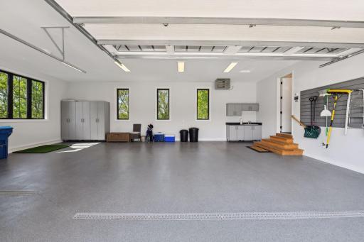 Finished and heated, the oversized garage offers Wombat epoxied floors with trough drains and is plumbed with a built-in utility sink and hose bib.