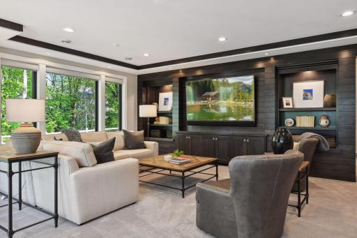 A second Family Room is perfect for movie night or cheering on your favorite sports teams. The built-in entertainment center features custom bookcases and cabinetry, and clear alder shiplap wrapped wall adding to the drama of the space.