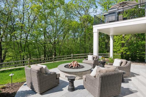 A custom bluestone paver patio features a firepit with plumbed gas line â enjoy connecting with family and friends while roasting Sâmores or sipping your favorite beverages.